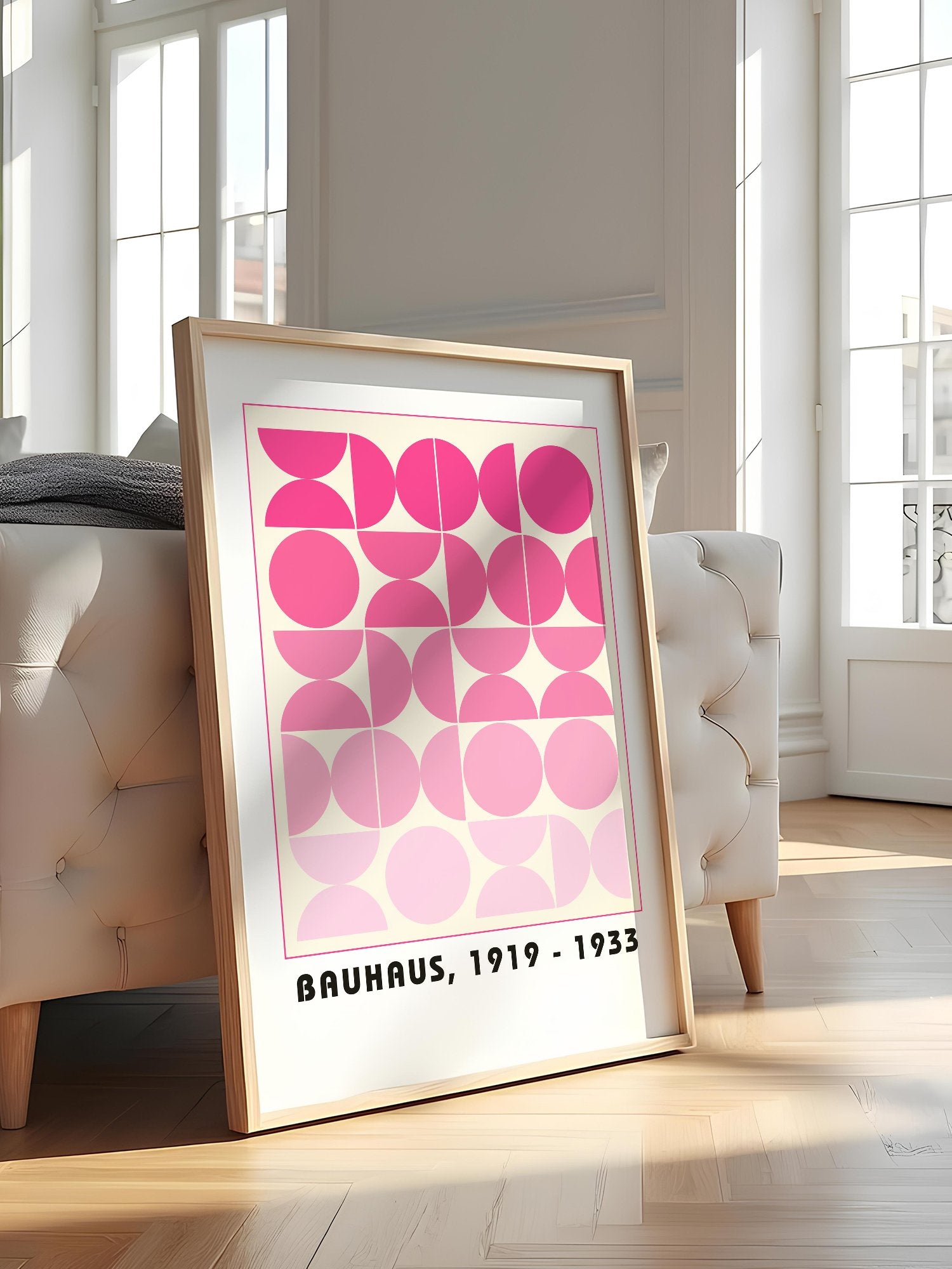 Bauhaus geometric poster featuring pink circles and semicircles in gradient, featured in stylish apartment decor