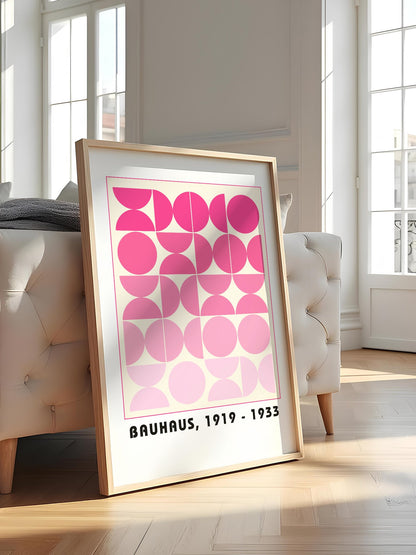 Bauhaus geometric poster featuring pink circles and semicircles in gradient, featured in stylish apartment decor