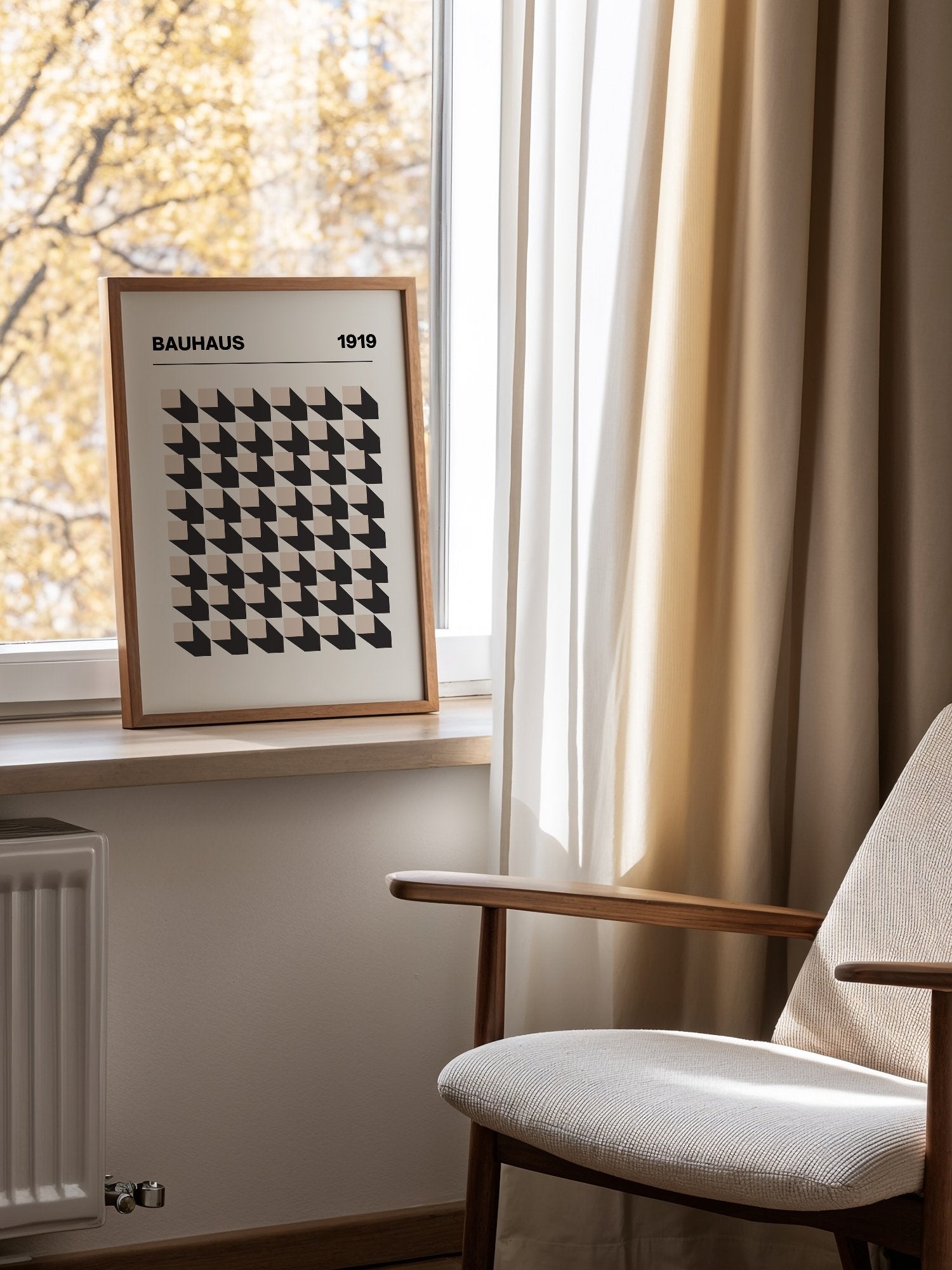 Bauhaus 1919 poster featuring grid of black and beige isometric cubes in, mounted in bright gallery wall arrangement