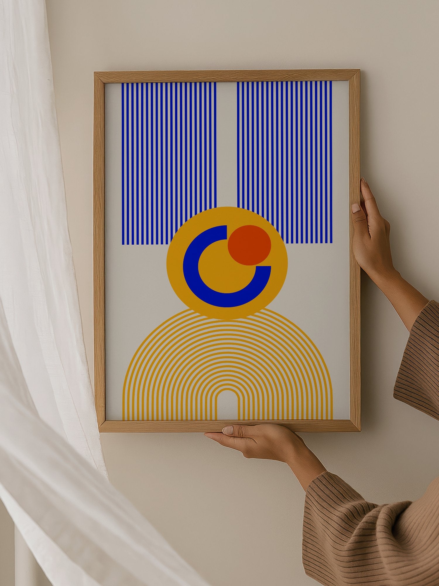 Bauhaus geometric abstract figure with concentric yellow stripes, blue crescent, hanging in contemporary bedroom interior