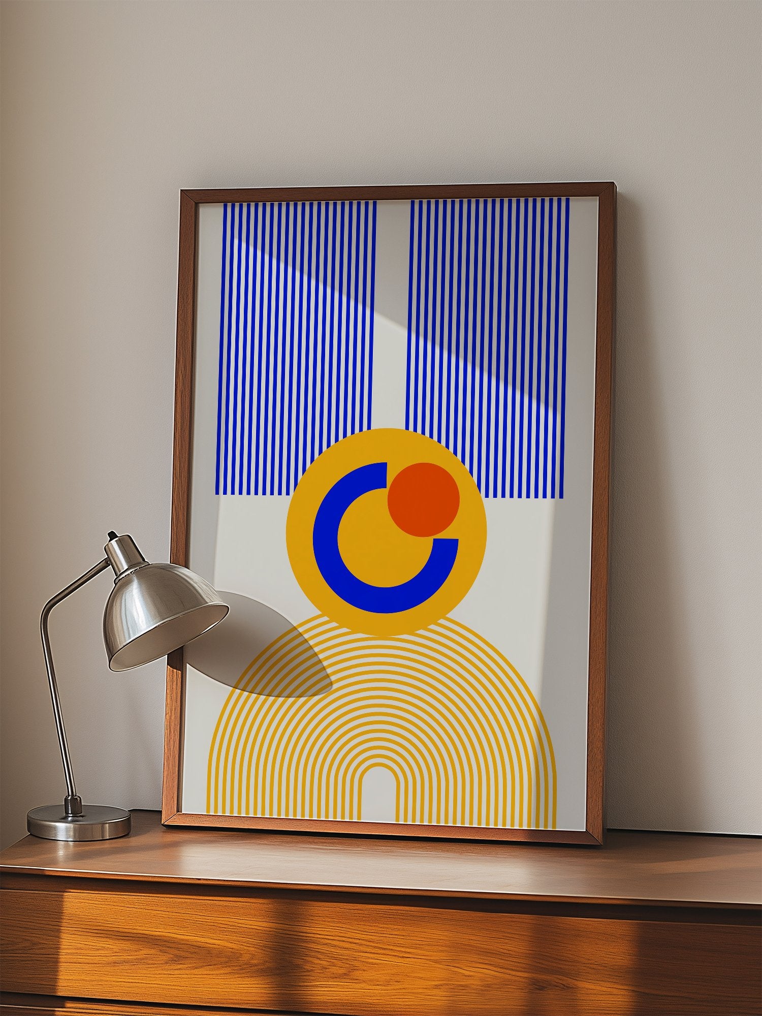 Bauhaus geometric abstract figure with concentric yellow stripes, blue crescent, displayed in modern living room setting