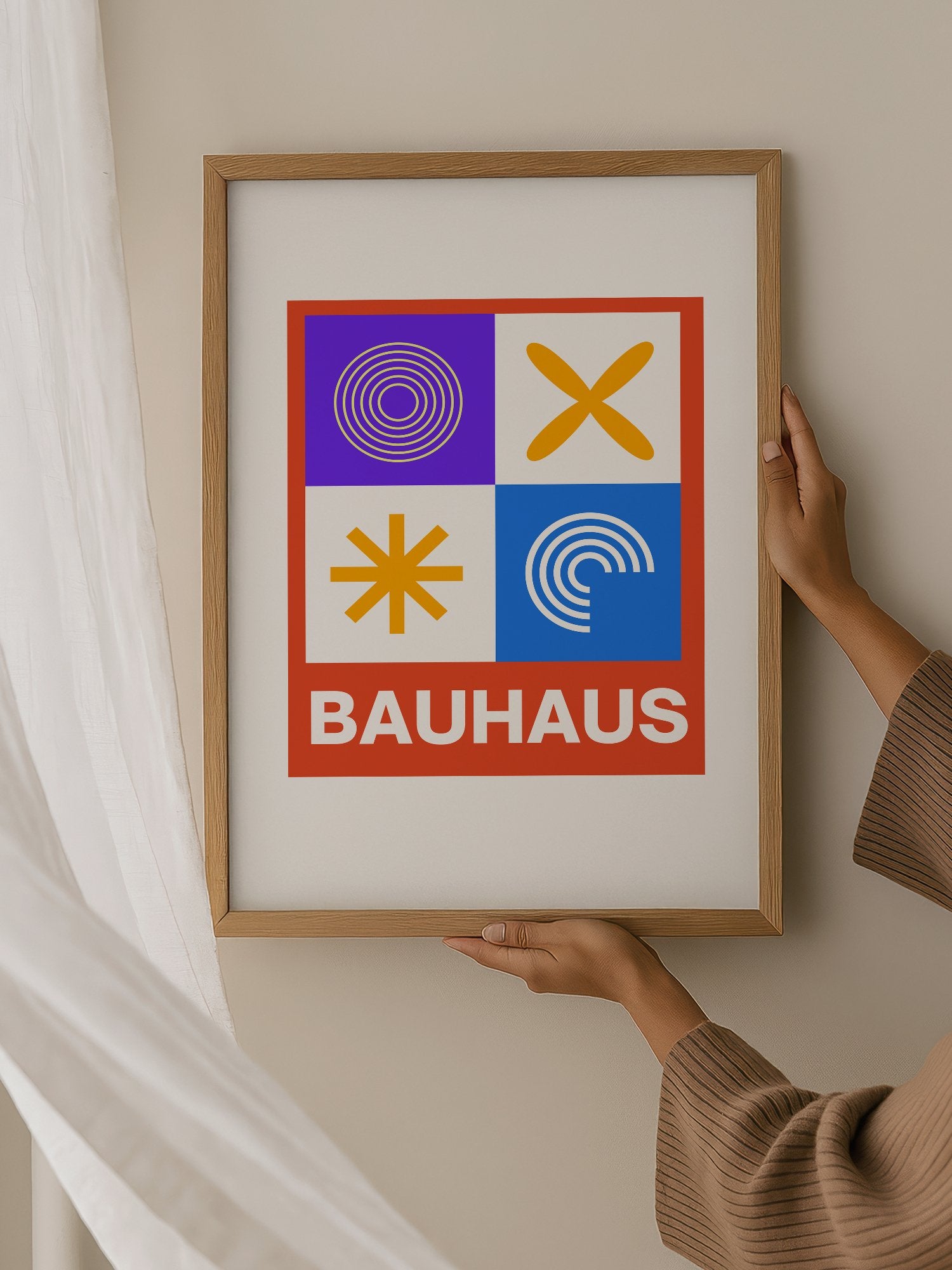 Bauhaus poster with geometric grid design featuring concentric circles, hanging in contemporary bedroom interior