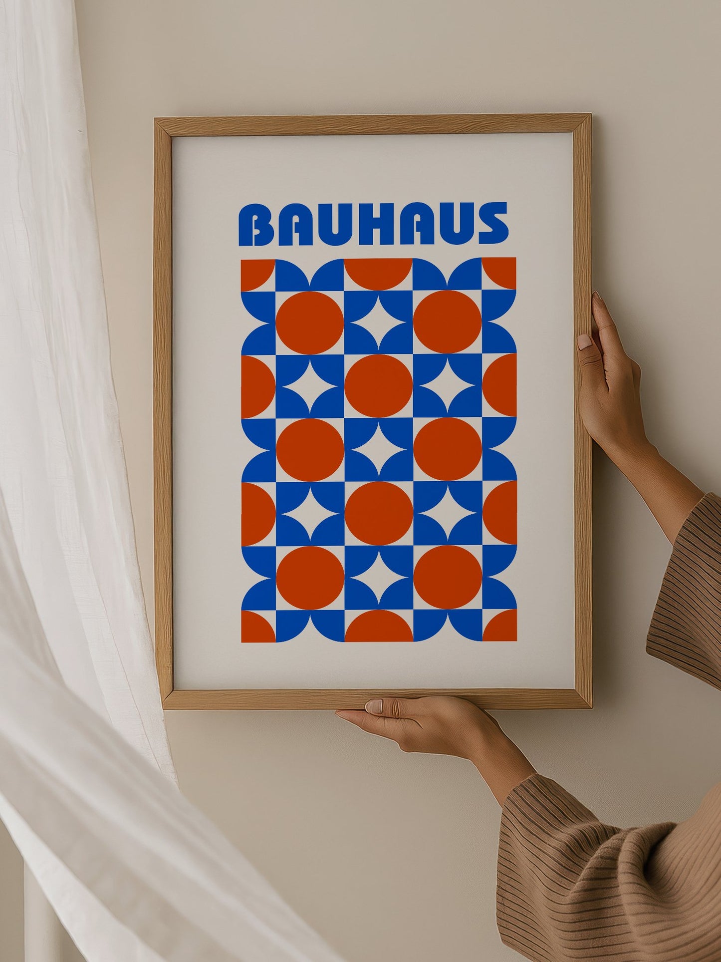 Bauhaus geometric poster with blue and orange quarter-circles in symmetrical, hanging in contemporary bedroom interior