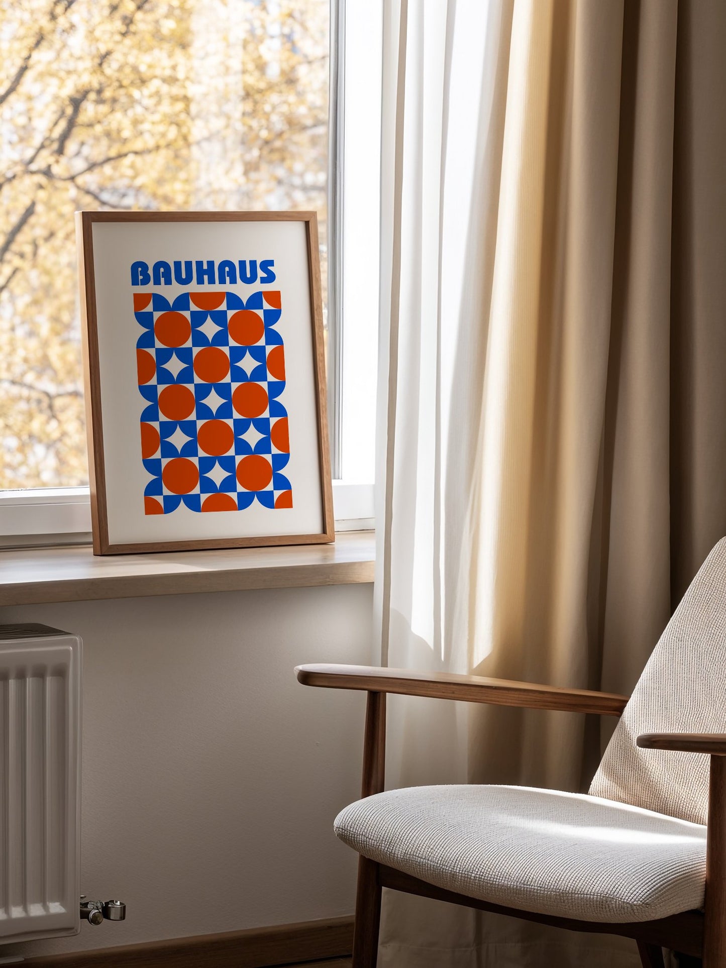 Bauhaus geometric poster with blue and orange quarter-circles in symmetrical, mounted in bright gallery wall arrangement