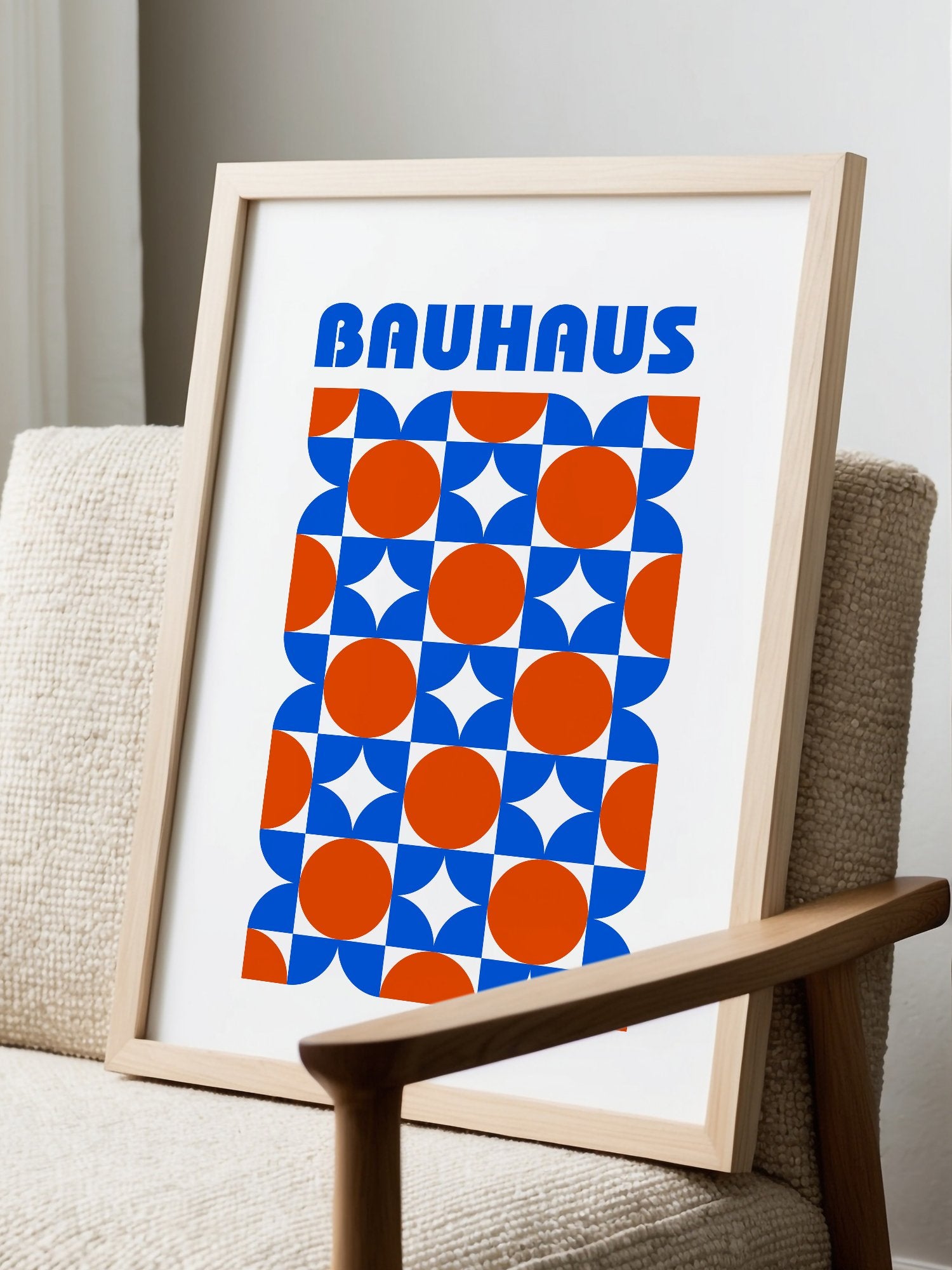 Bauhaus geometric poster with blue and orange quarter-circles in symmetrical, displayed in modern living room setting