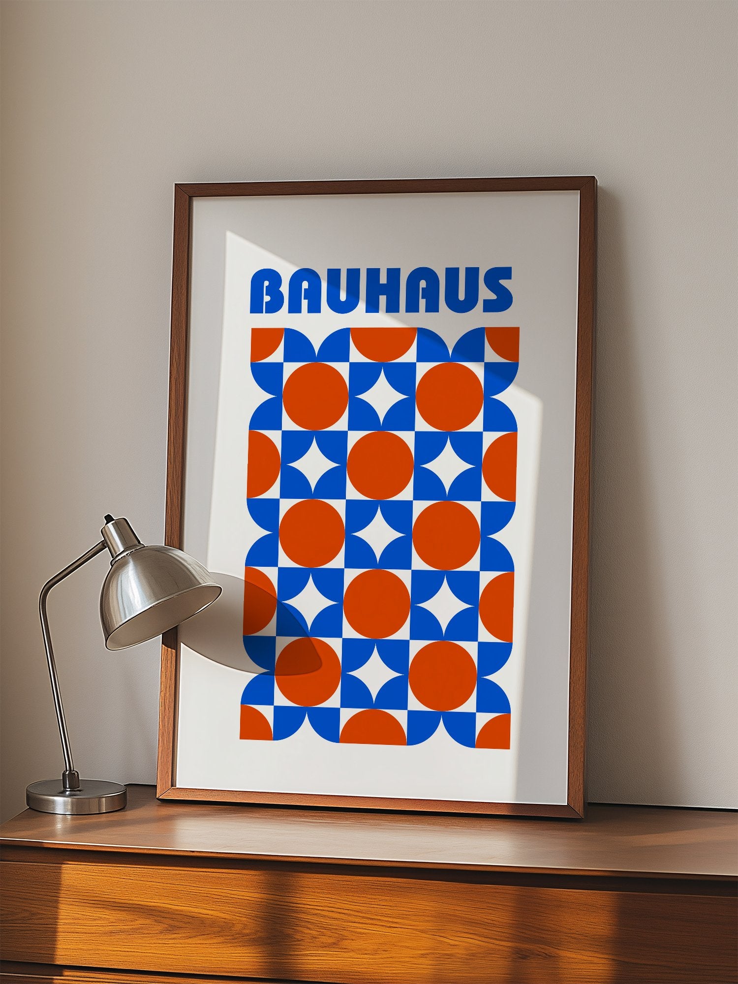 Bauhaus geometric poster with blue and orange quarter-circles in symmetrical, displayed in modern living room setting
