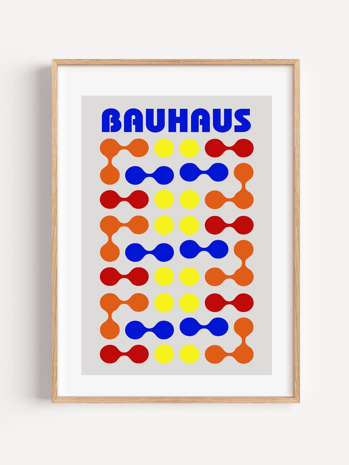 Bauhaus poster with bold blue typography and geometric grid pattern of circles, close-up showing print texture and color d...