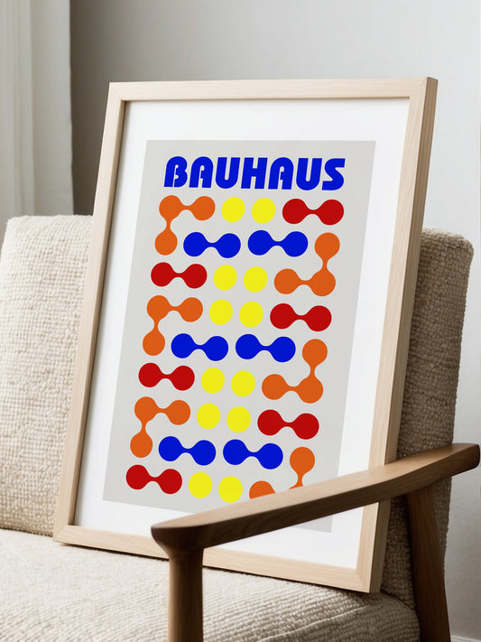 Bauhaus poster with bold blue typography and geometric grid pattern of circles, displayed in modern living room setting