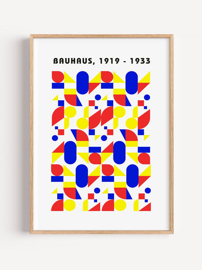 Bauhaus geometric poster with red circles, yellow triangles, and blue ovals in, close-up showing print texture and color d...