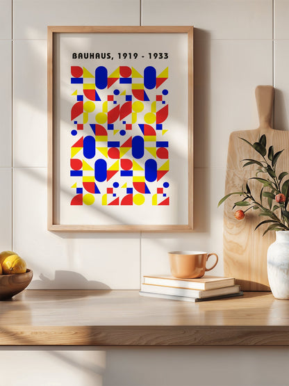 Bauhaus geometric poster with red circles, yellow triangles, and blue ovals in, hanging in contemporary bedroom interior