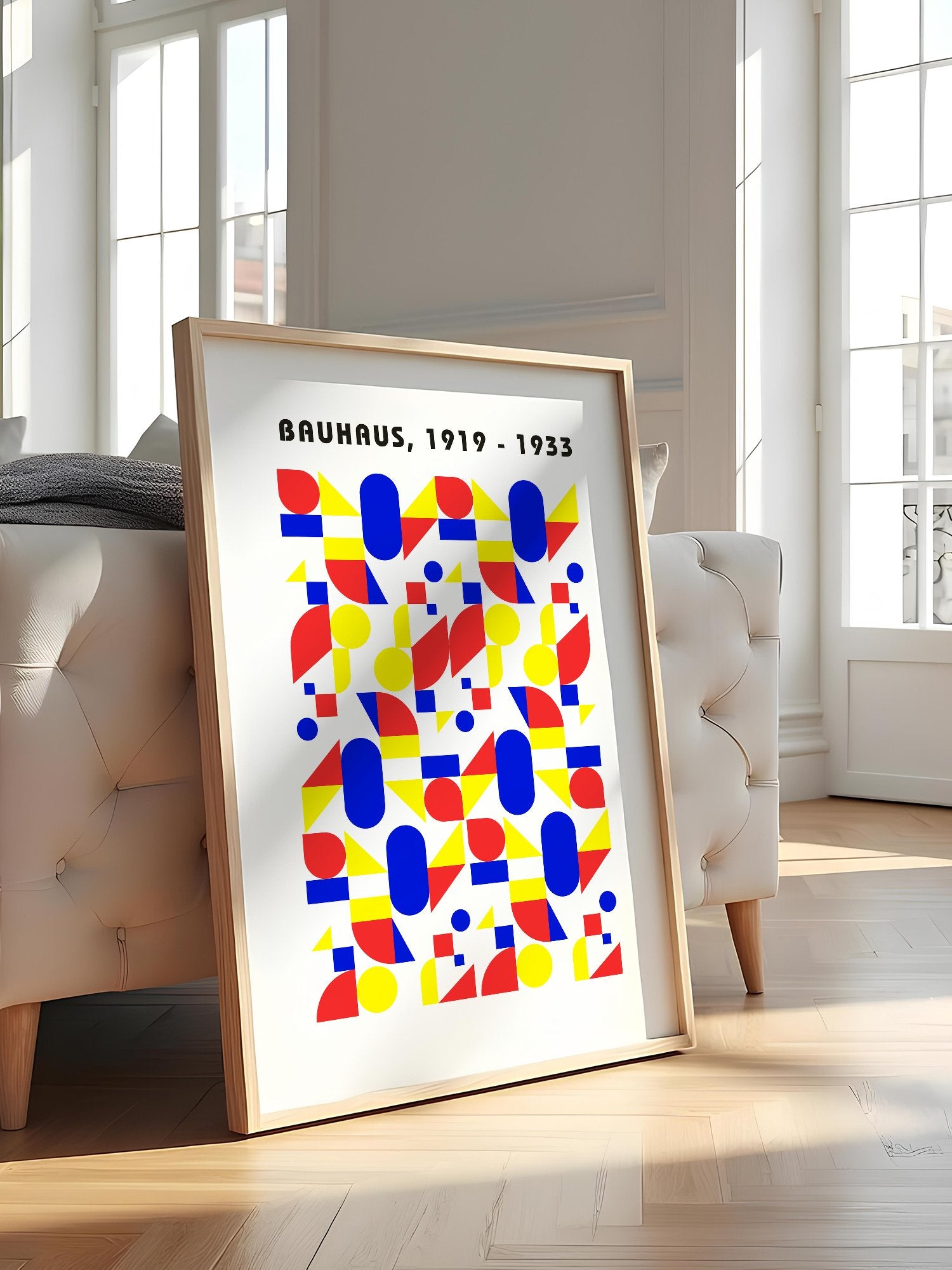 Bauhaus geometric poster with red circles, yellow triangles, and blue ovals in, featured in stylish apartment decor