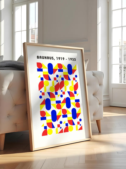 Bauhaus geometric poster with red circles, yellow triangles, and blue ovals in, featured in stylish apartment decor