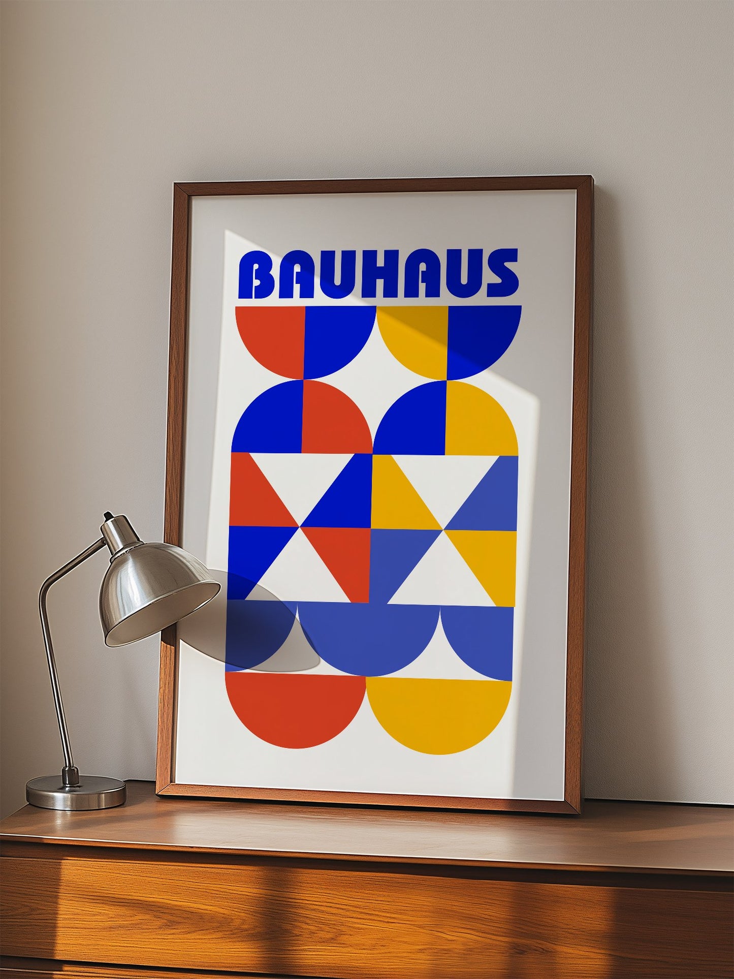 Bauhaus geometric poster featuring bold blue typography above symmetrical, displayed in modern living room setting