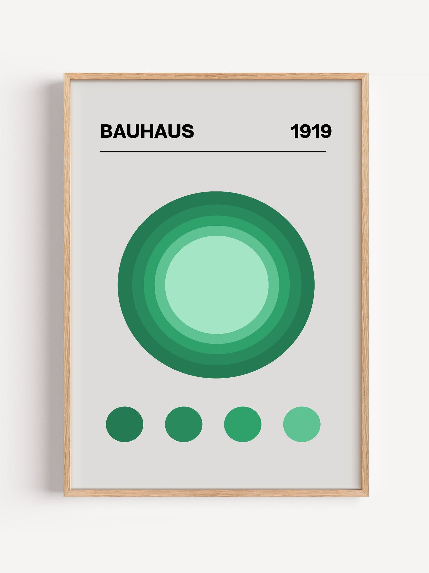 Bauhaus 1919 poster with concentric green circles in gradient shades on beige, close-up showing print texture and color de...