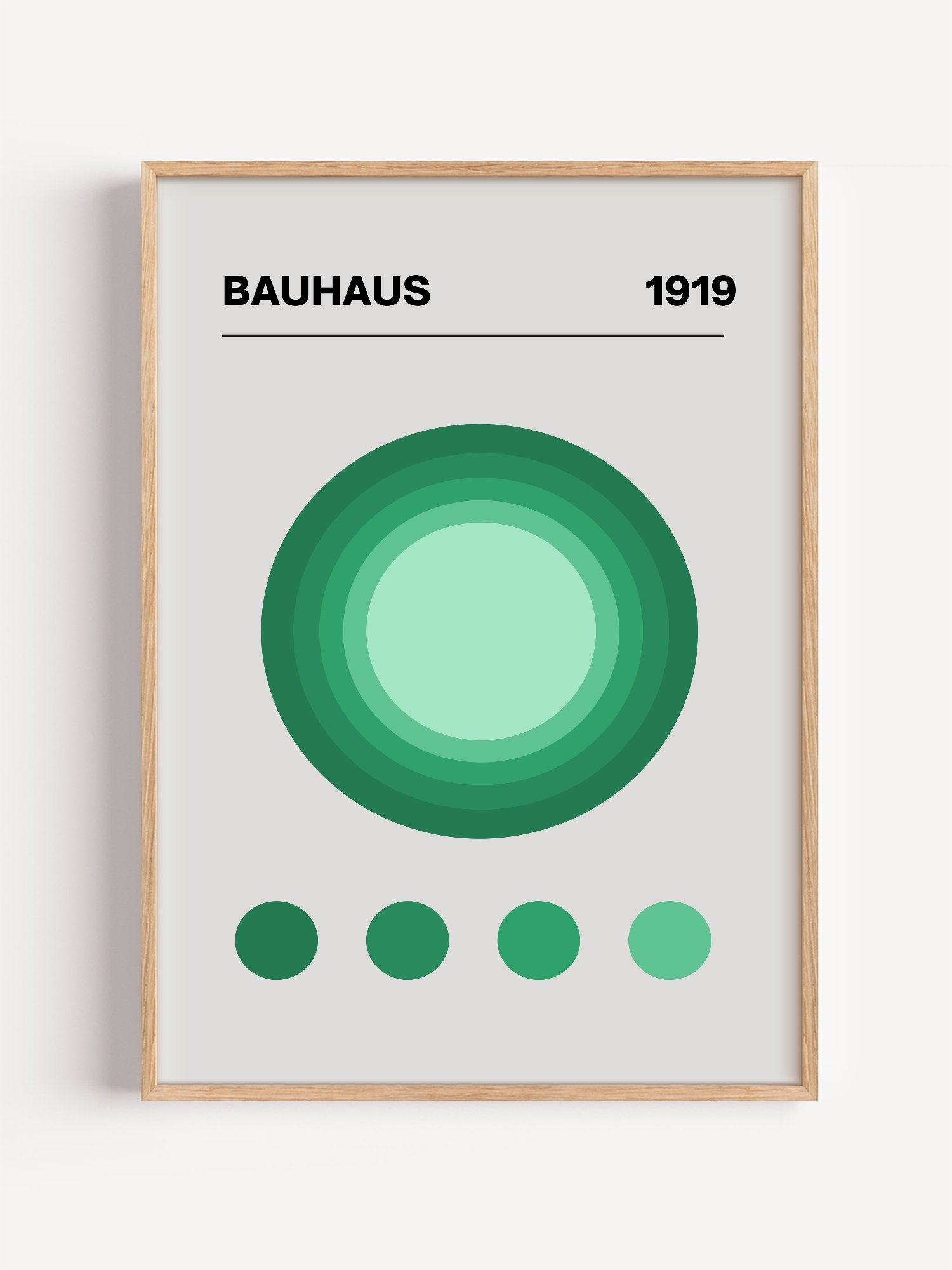 Bauhaus 1919 poster with concentric green circles in gradient shades on beige, close-up showing print texture and color de...