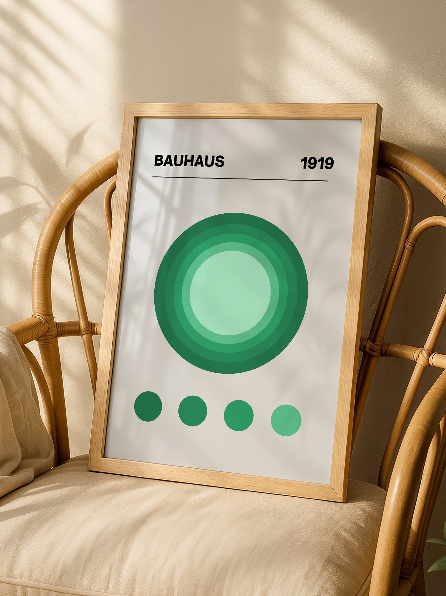 Bauhaus 1919 poster with concentric green circles in gradient shades on beige, shown in minimalist home office space