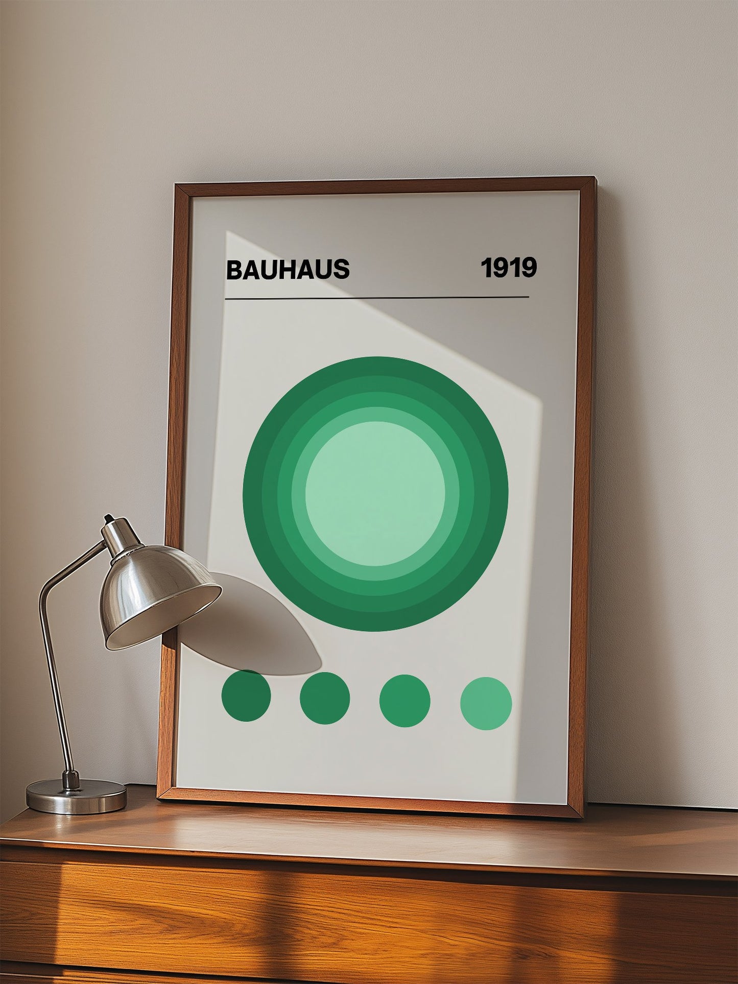Bauhaus 1919 poster with concentric green circles in gradient shades on beige, displayed in modern living room setting