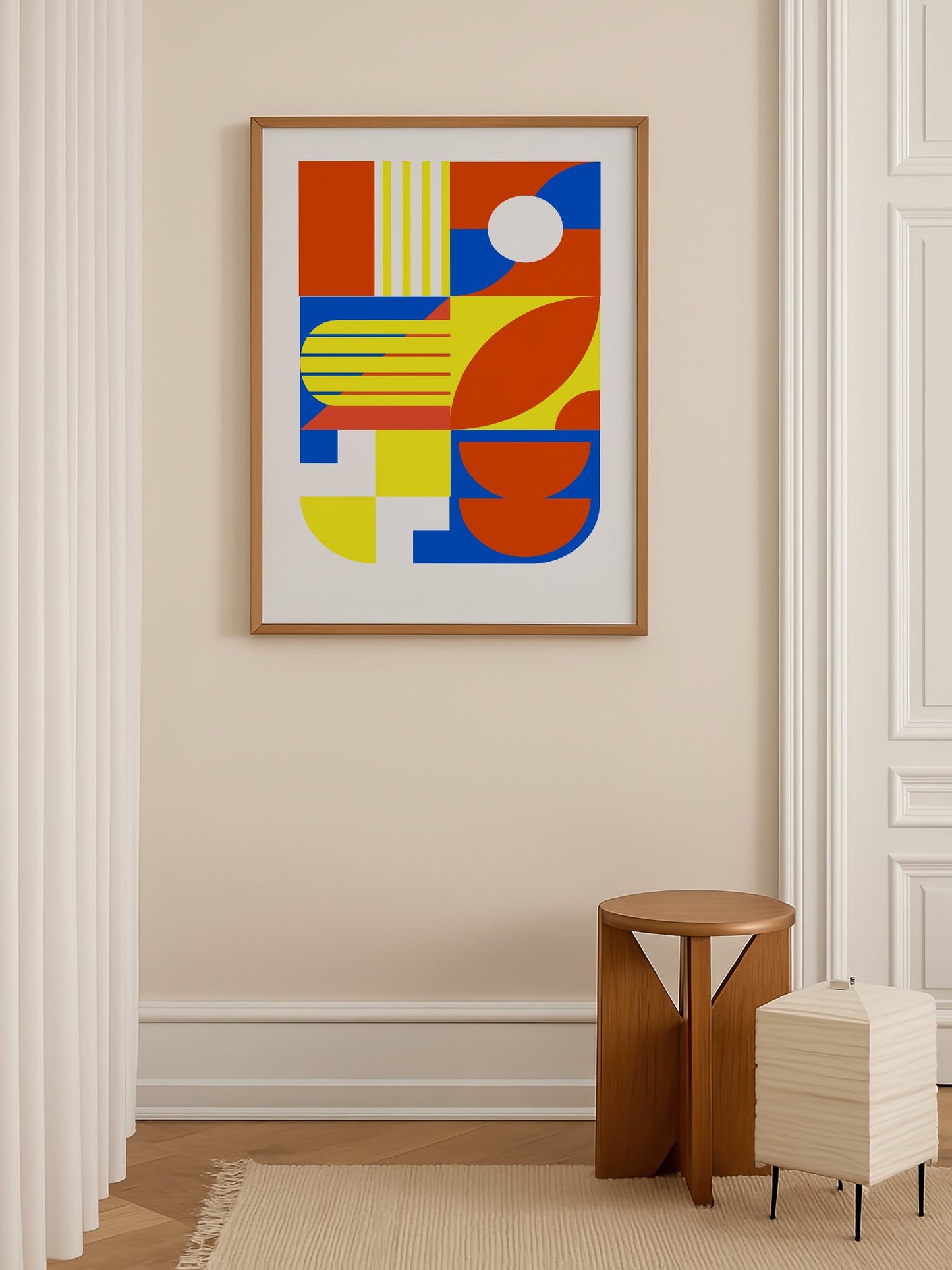 Abstract geometric wall art with interlocking orange, blue and yellow shapes, shown in minimalist home office space