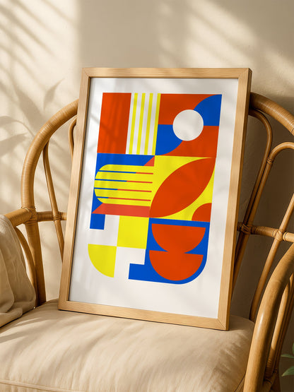 Abstract geometric wall art with interlocking orange, blue and yellow shapes, shown in minimalist home office space