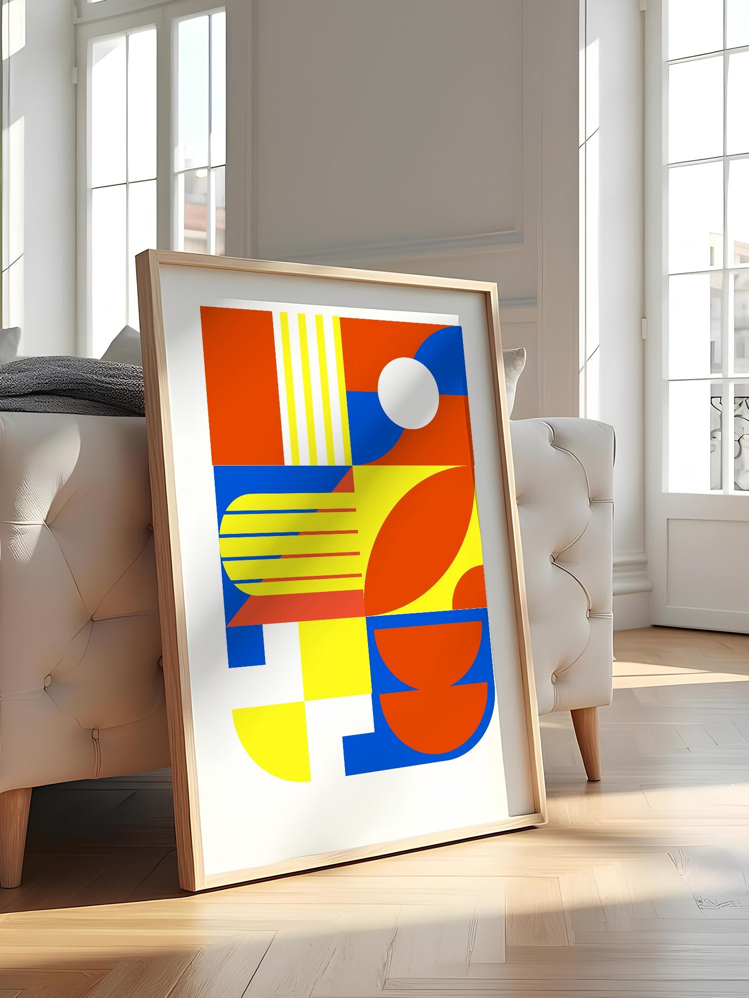 Abstract geometric wall art with interlocking orange, blue and yellow shapes, featured in stylish apartment decor