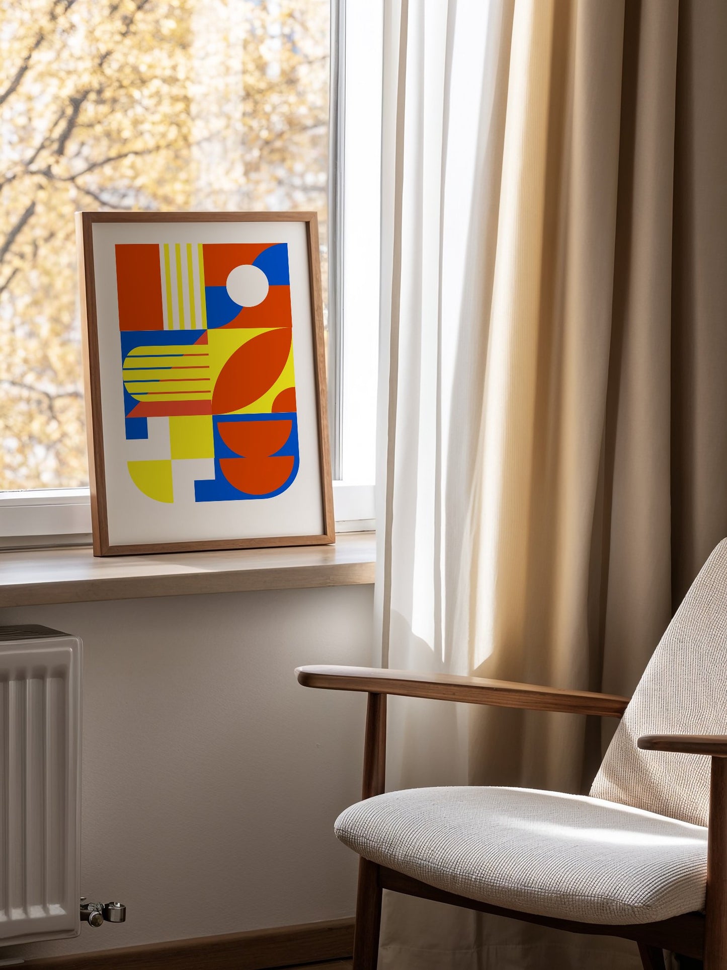 Abstract geometric wall art with interlocking orange, blue and yellow shapes, mounted in bright gallery wall arrangement