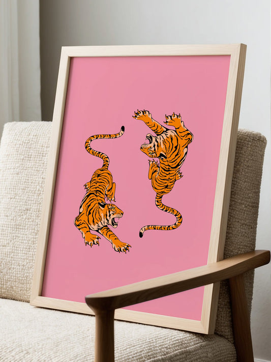 Two tigers in dynamic fighting poses with bold black outlines on vibrant pink, displayed in modern living room setting