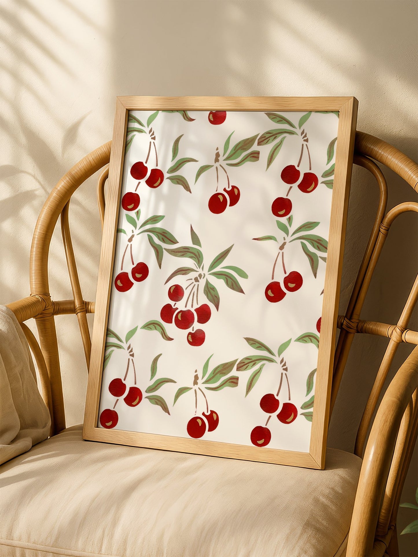 Repeating cherry botanical pattern with red fruit clusters and green leaves on, shown in minimalist home office space