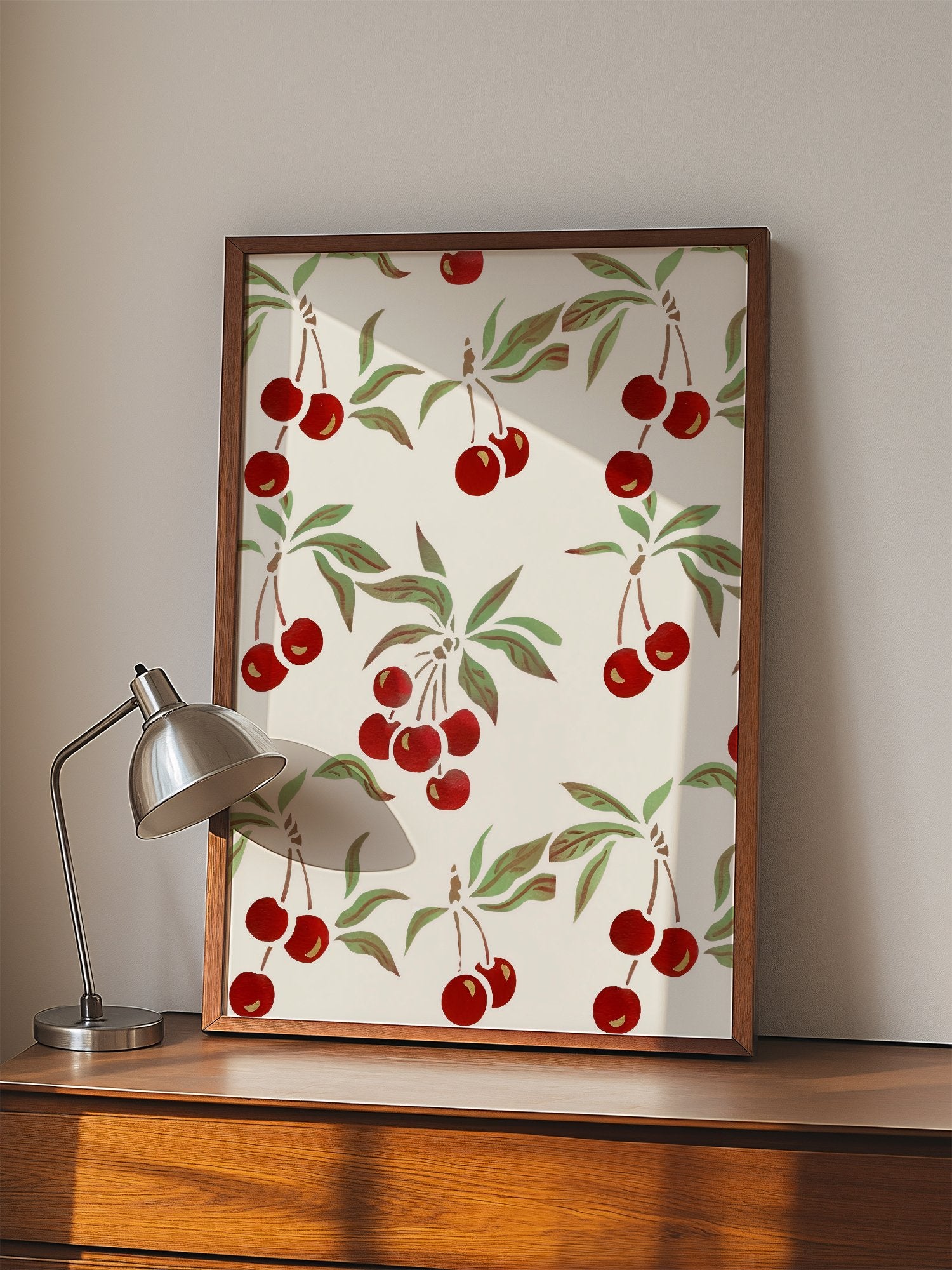 Repeating cherry botanical pattern with red fruit clusters and green leaves on, displayed in modern living room setting