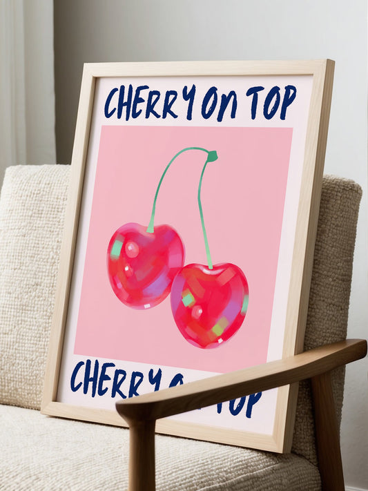 Cherry illustration print featuring two glossy red cherries on pink background, displayed in modern living room setting