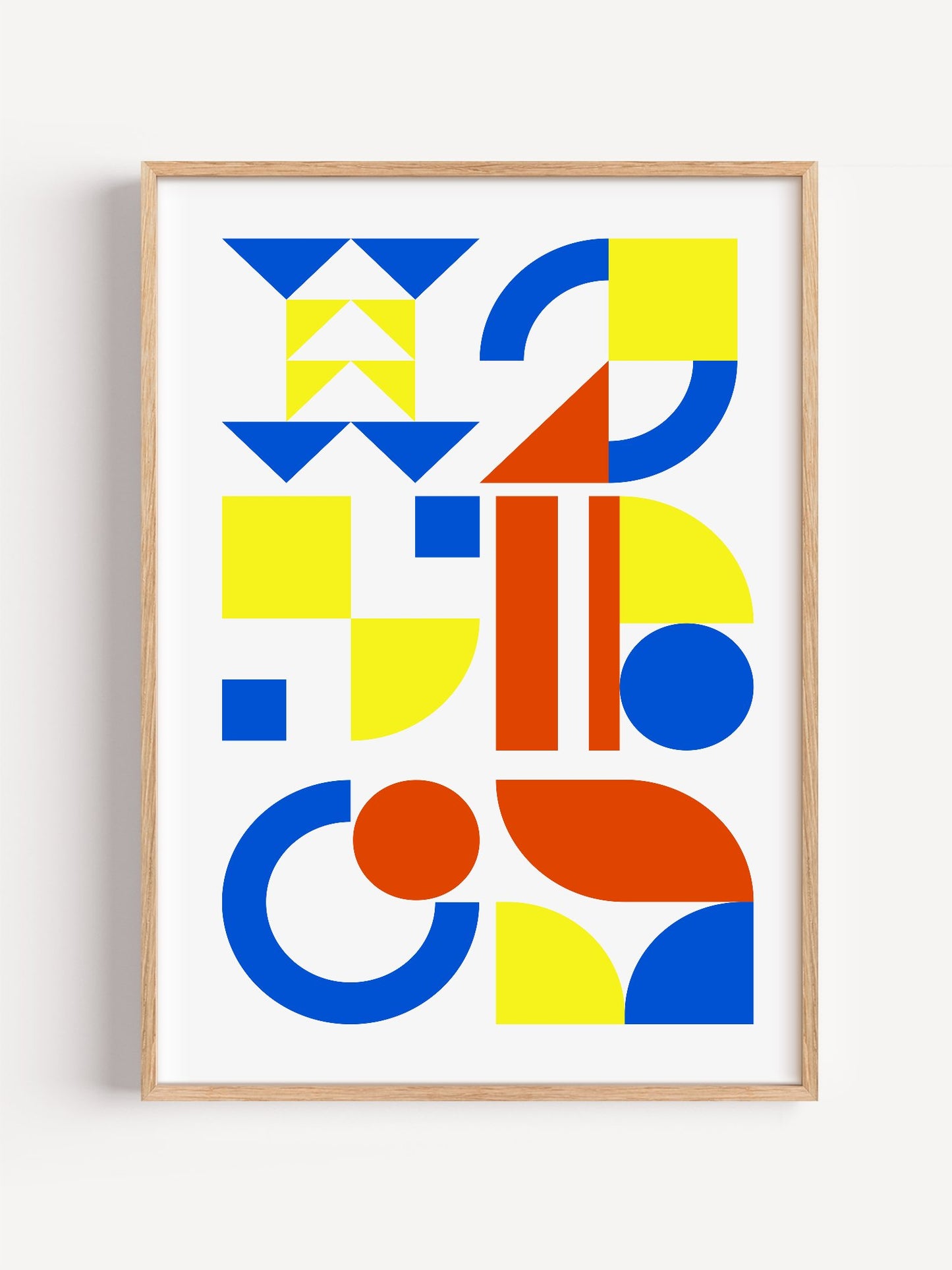 Geometric abstract wall art with blue, yellow and red triangles, circles and, close-up showing print texture and color detail