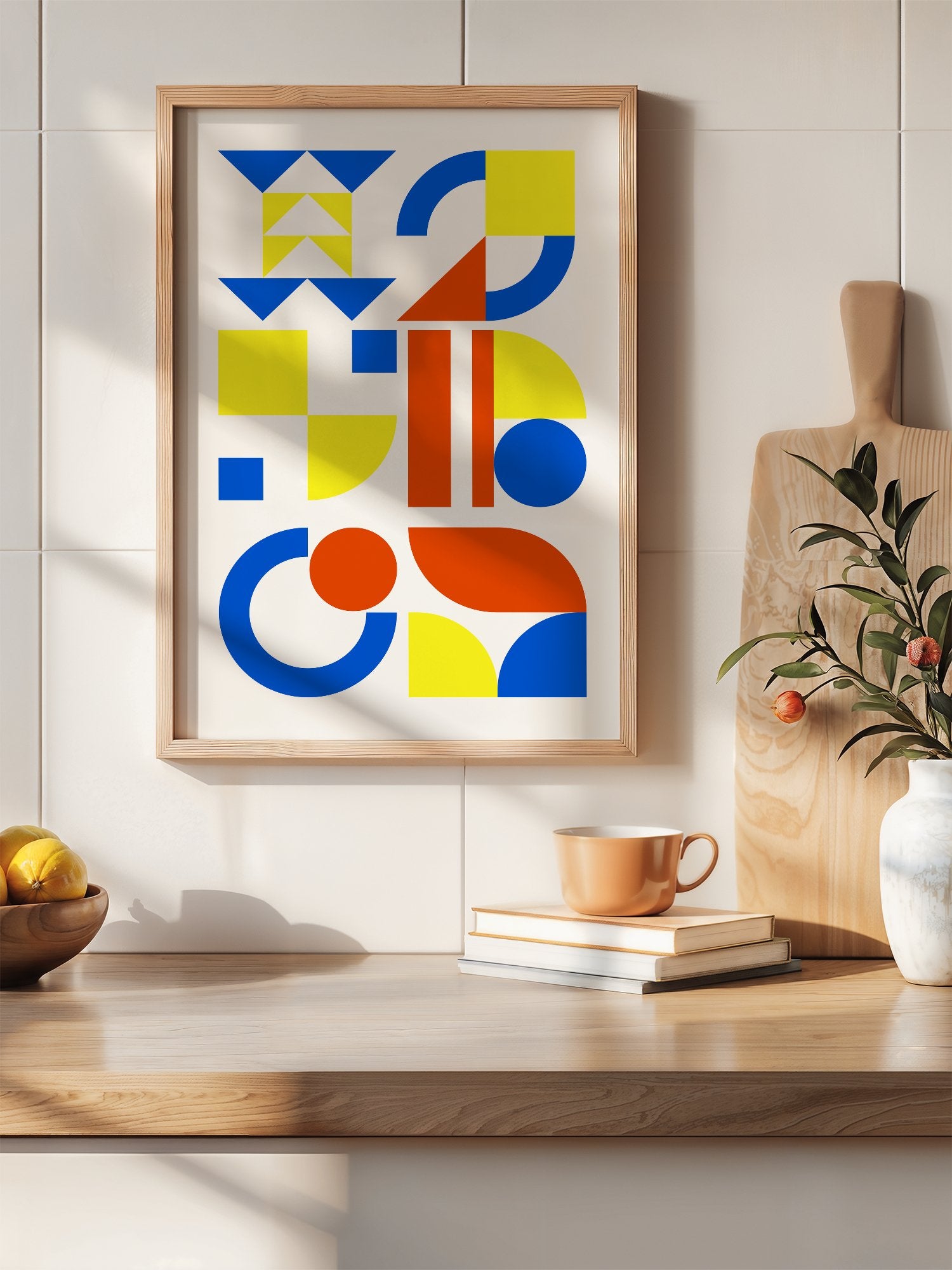 Geometric abstract wall art with blue, yellow and red triangles, circles and, hanging in contemporary bedroom interior