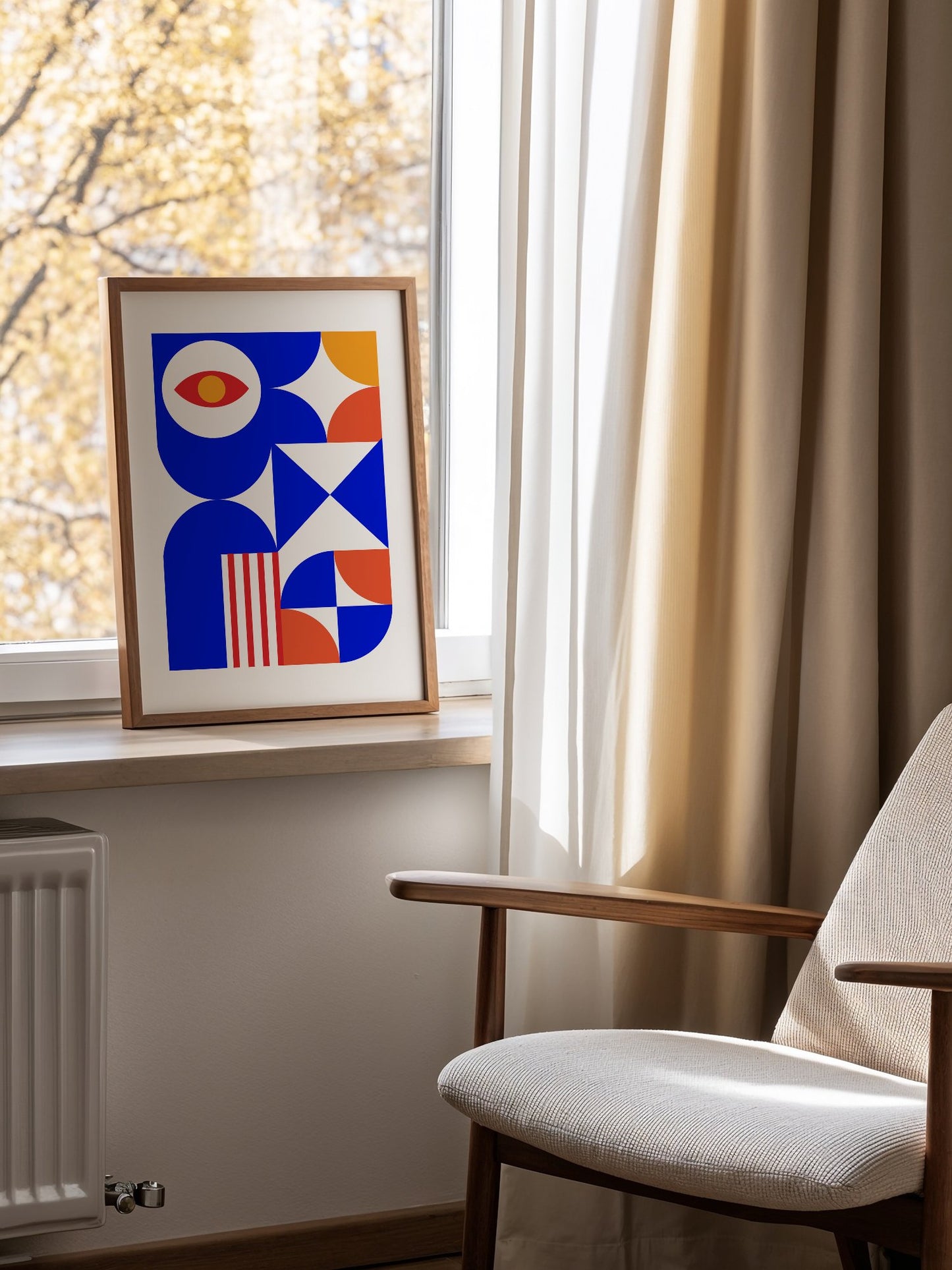 Geometric abstract art print with red eye motif, blue background, coral and, mounted in bright gallery wall arrangement