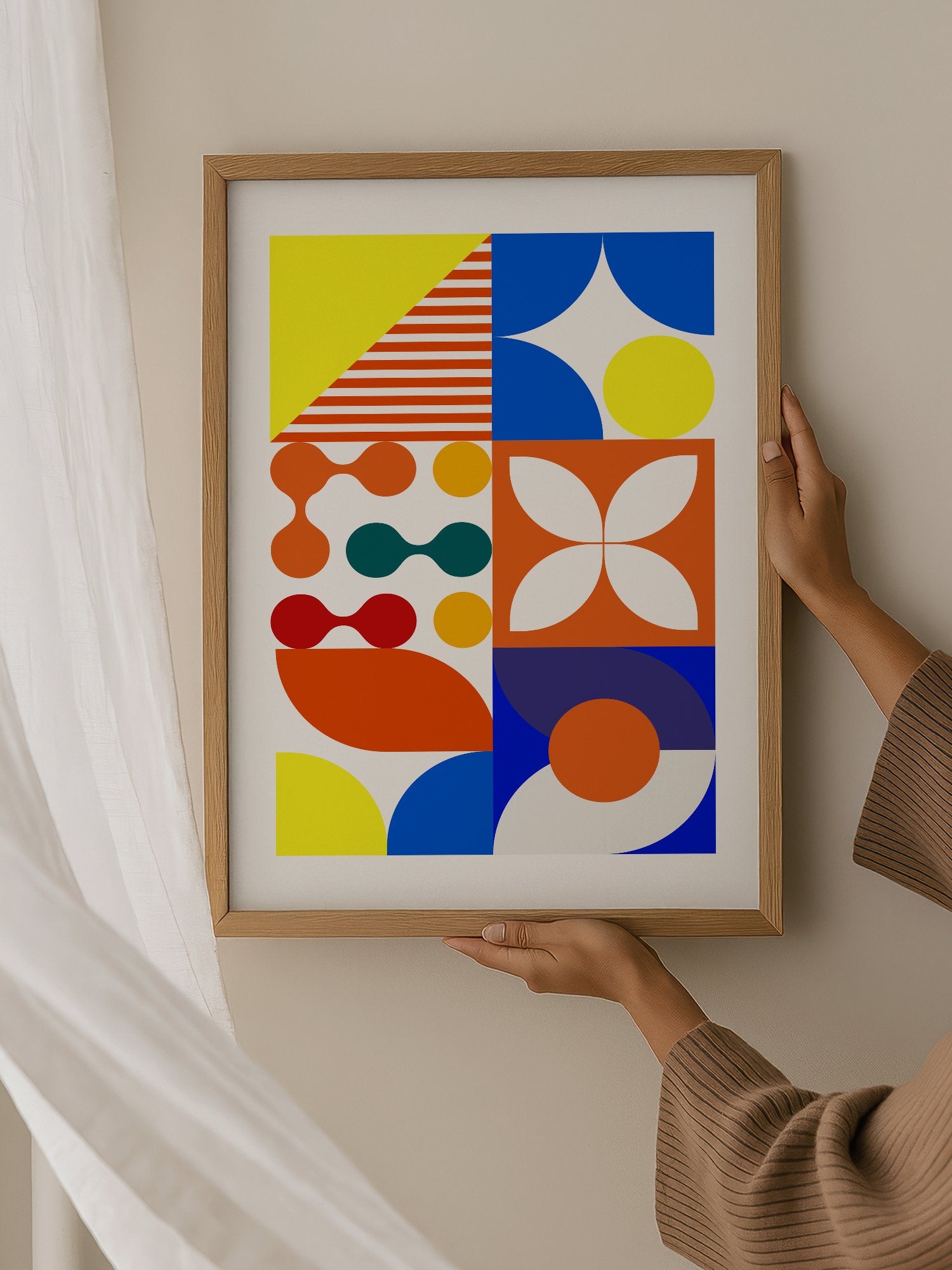 Geometric abstract wall art with bold blue curves, orange circles, yellow, hanging in contemporary bedroom interior