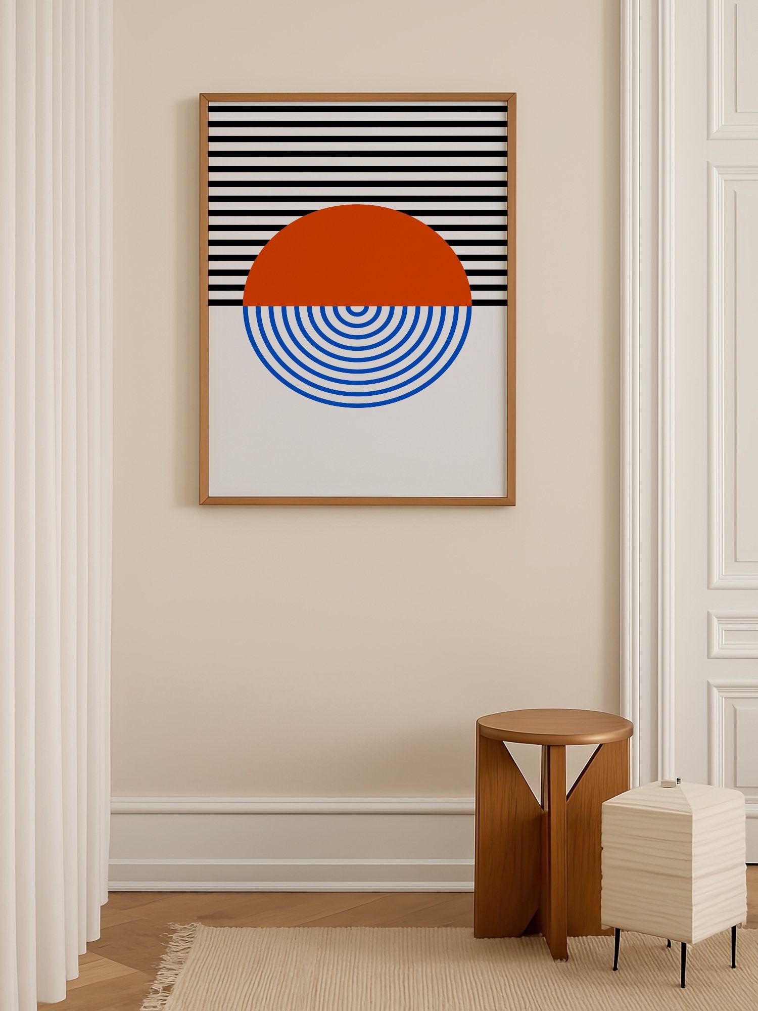Geometric abstract wall art featuring split circle with orange top and blue, shown in minimalist home office space