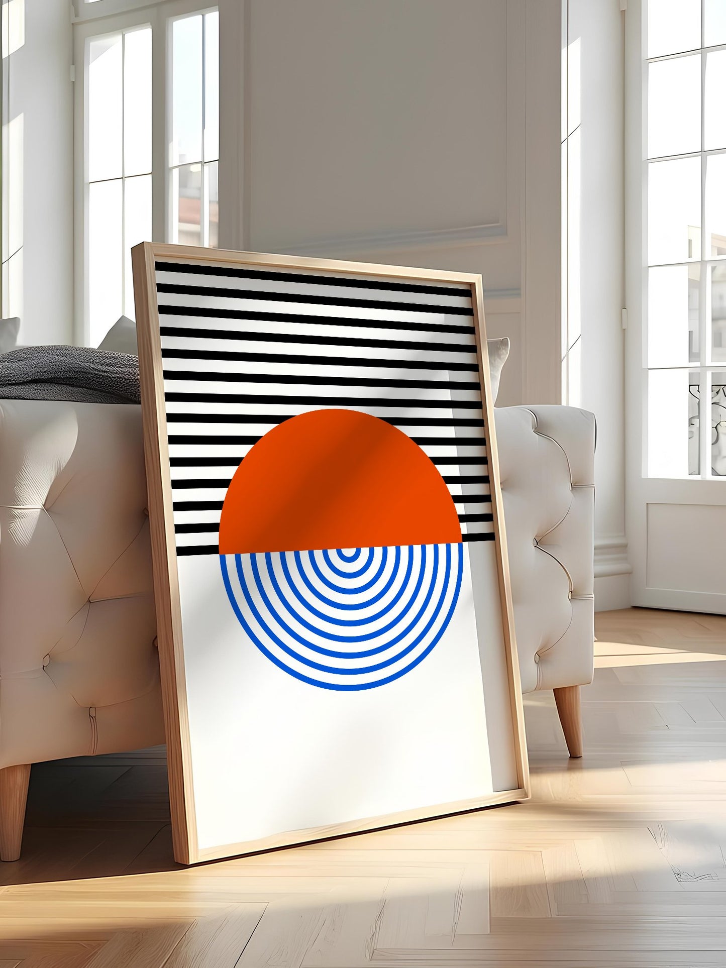 Geometric abstract wall art featuring split circle with orange top and blue, featured in stylish apartment decor