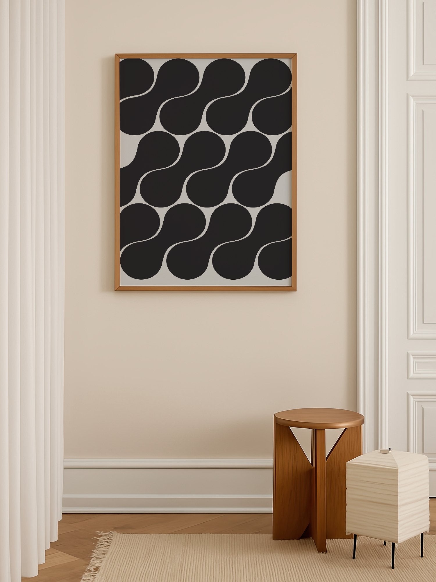 Geometric wall art print featuring interlocking black circles in grid pattern, shown in minimalist home office space