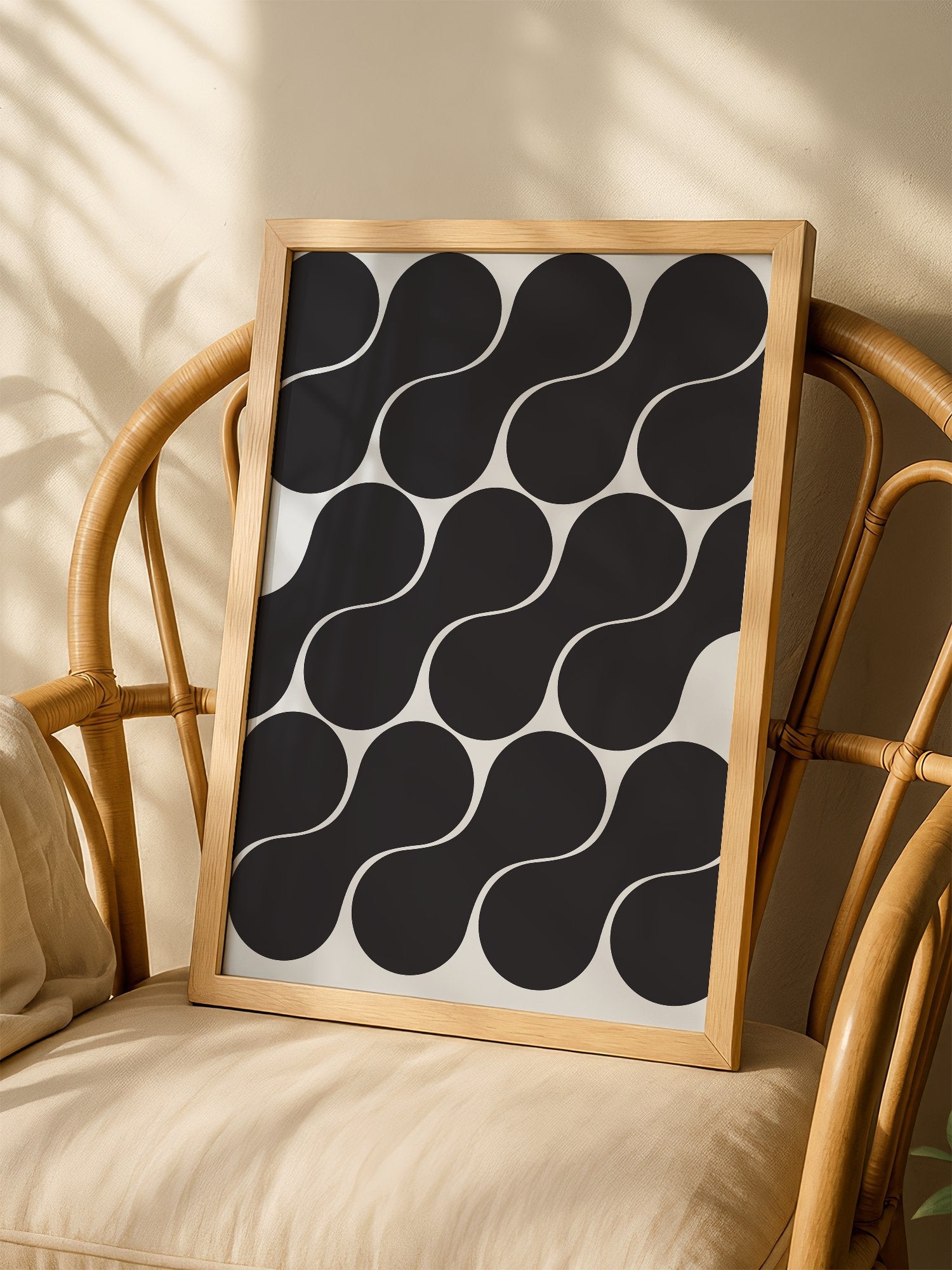 Geometric wall art print featuring interlocking black circles in grid pattern, shown in minimalist home office space