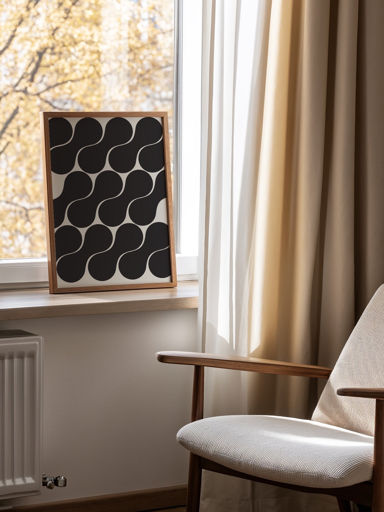 Geometric wall art print featuring interlocking black circles in grid pattern, mounted in bright gallery wall arrangement
