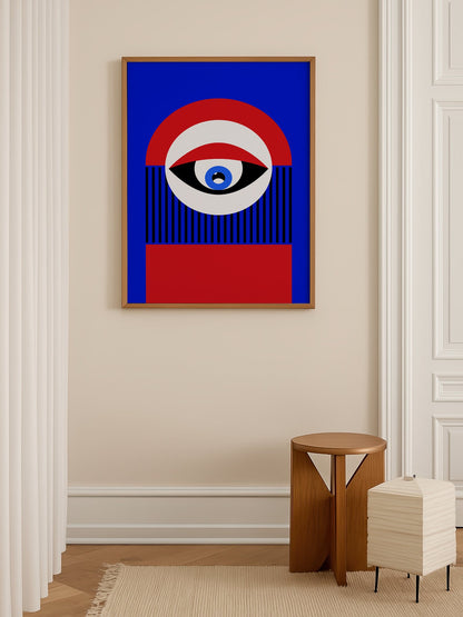 Abstract geometric portrait art with bold central eye motif in cobalt blue, shown in minimalist home office space