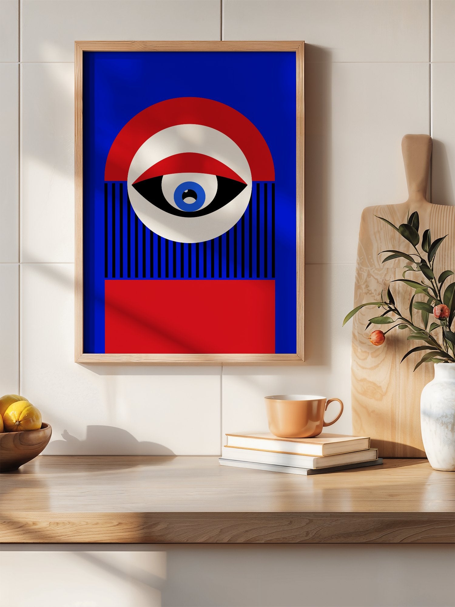 Abstract geometric portrait art with bold central eye motif in cobalt blue, hanging in contemporary bedroom interior