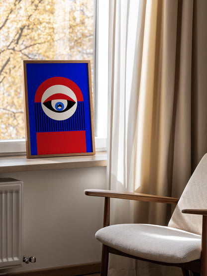 Abstract geometric portrait art with bold central eye motif in cobalt blue, mounted in bright gallery wall arrangement