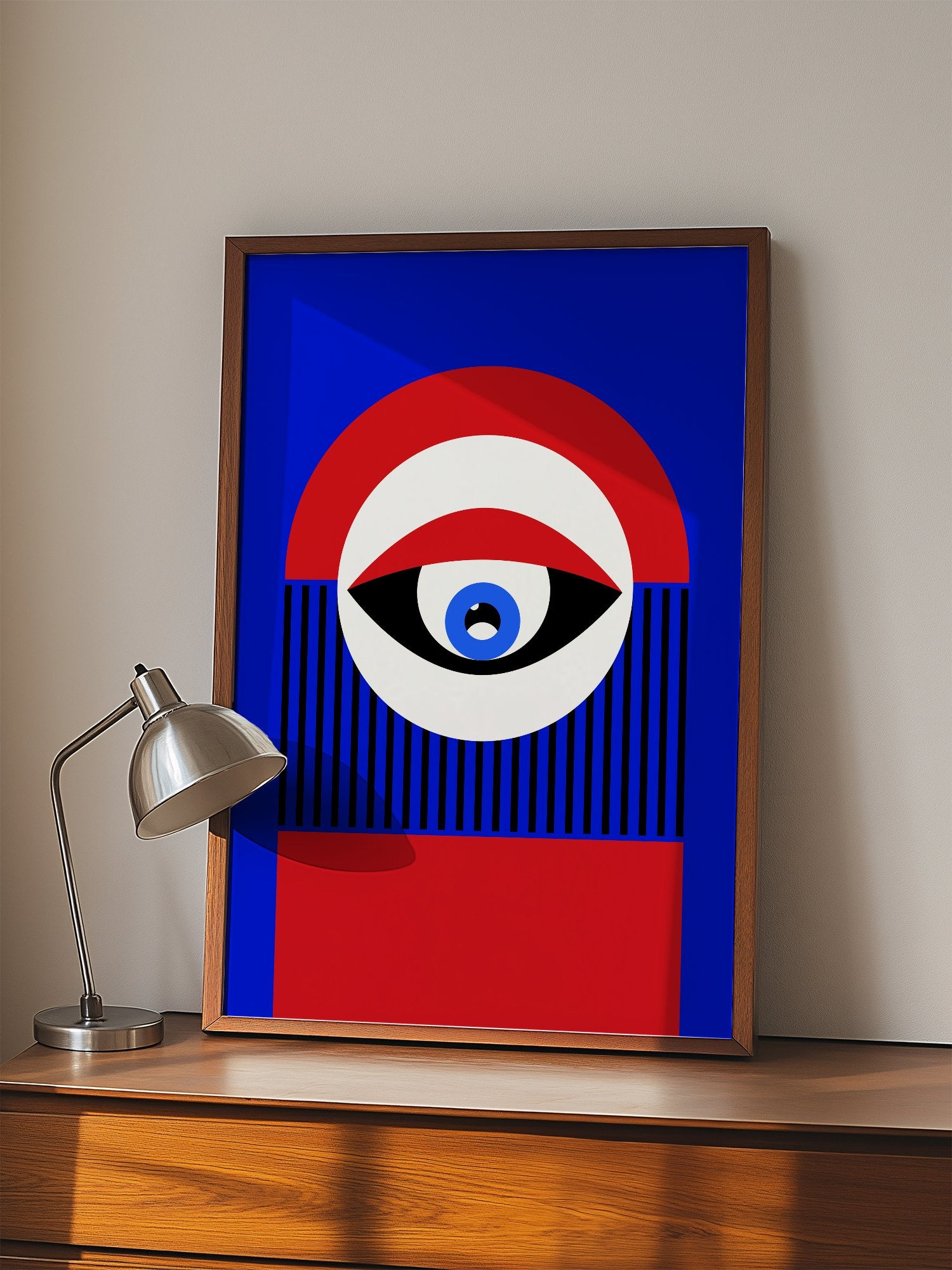 Abstract geometric portrait art with bold central eye motif in cobalt blue, displayed in modern living room setting
