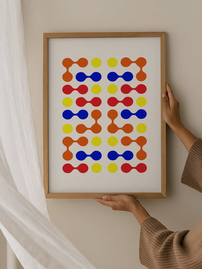 Mid-century modern geometric print with colourful molecular shapes in orange, hanging in contemporary bedroom interior