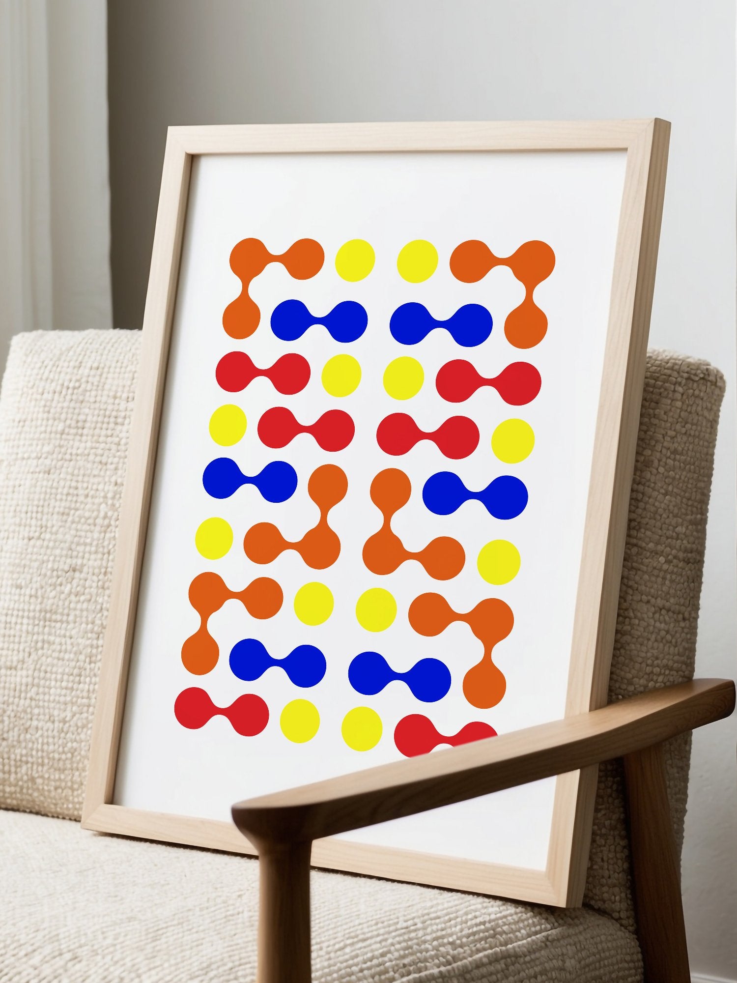 Mid-century modern geometric print with colourful molecular shapes in orange, displayed in modern living room setting