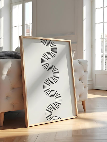 Minimalist abstract wall art with flowing black wave lines creating S-curve, featured in stylish apartment decor