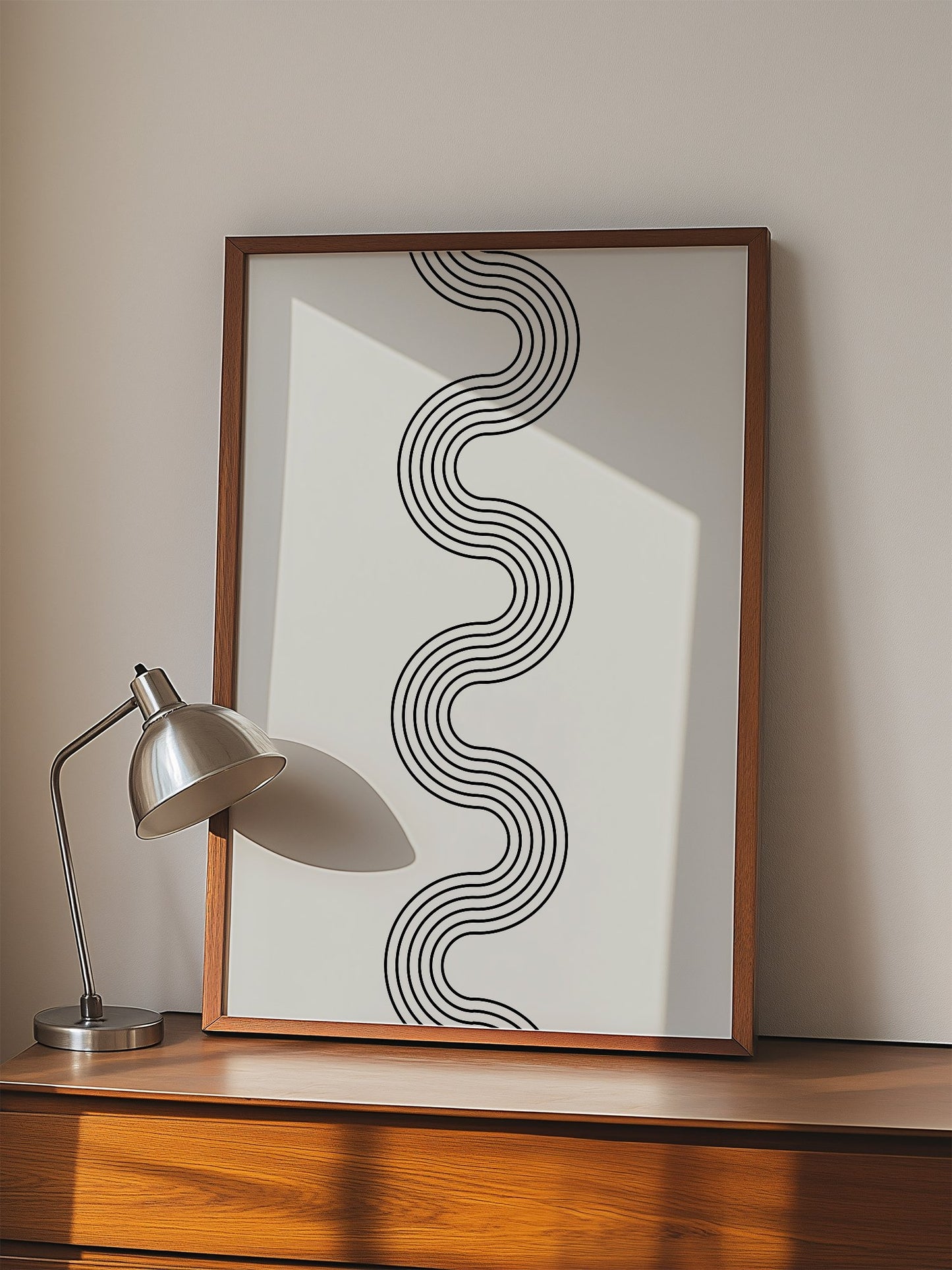 Minimalist abstract wall art with flowing black wave lines creating S-curve, displayed in modern living room setting