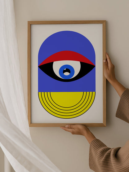 Pop art portrait print featuring geometric eye with concentric circles in blue, hanging in contemporary bedroom interior