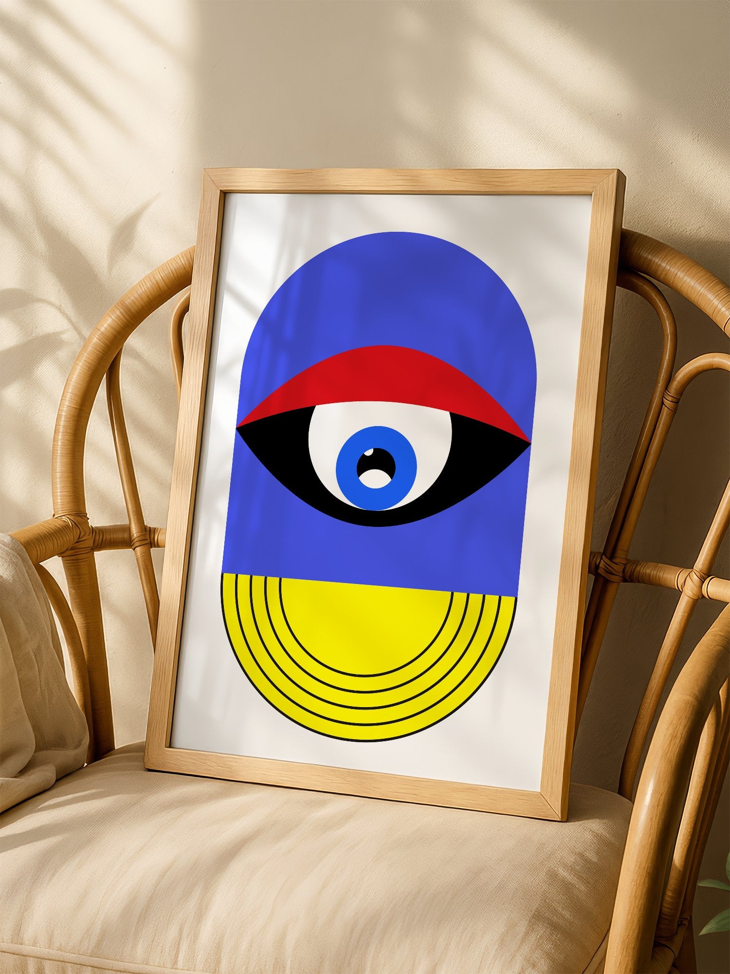 Pop art portrait print featuring geometric eye with concentric circles in blue, shown in minimalist home office space
