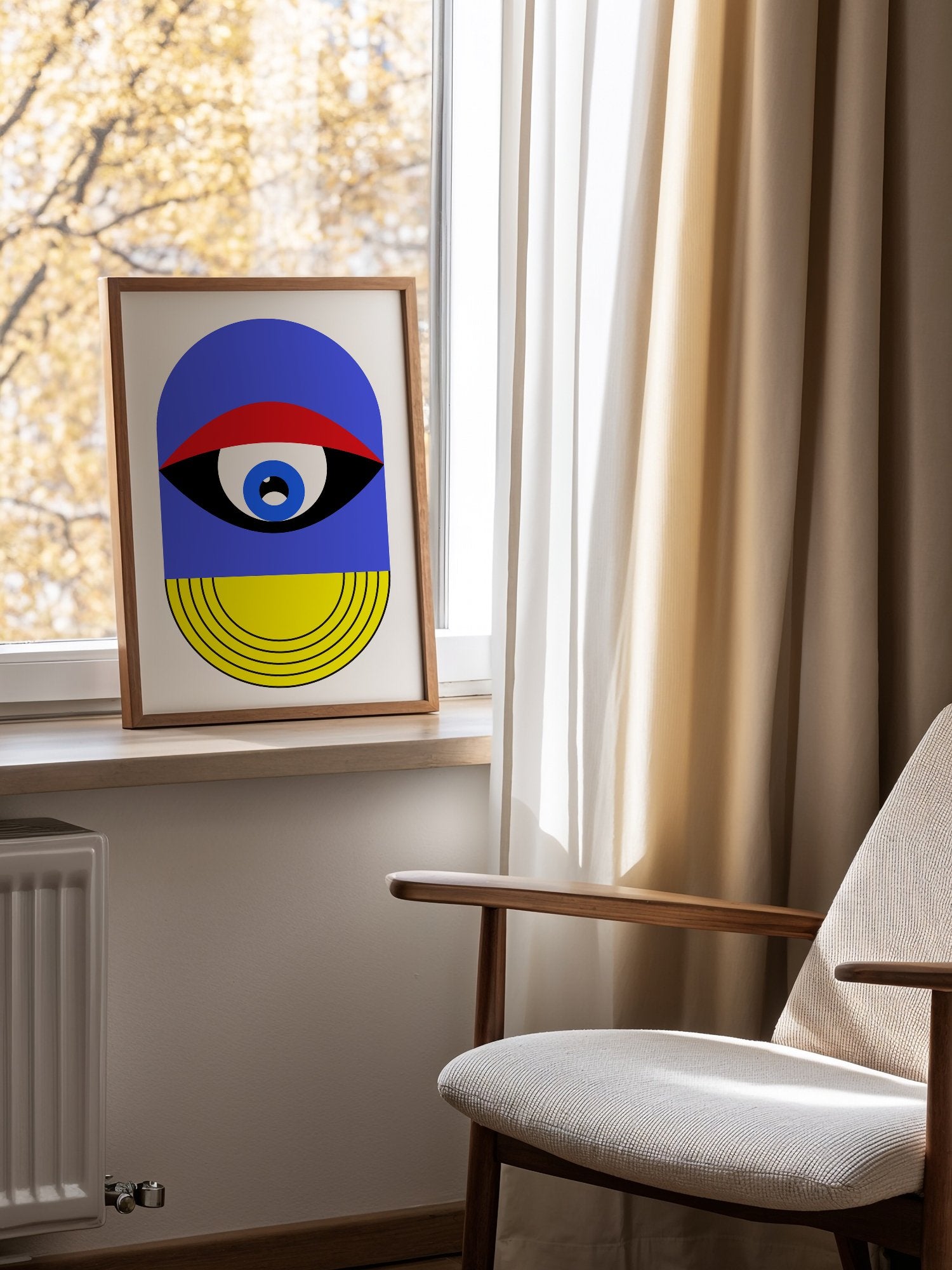 Pop art portrait print featuring geometric eye with concentric circles in blue, mounted in bright gallery wall arrangement