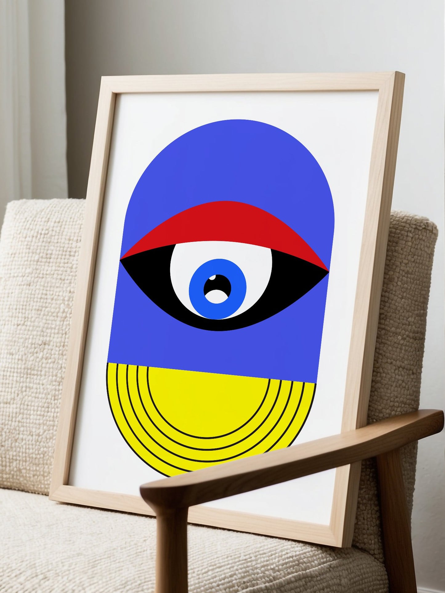 Pop art portrait print featuring geometric eye with concentric circles in blue, displayed in modern living room setting